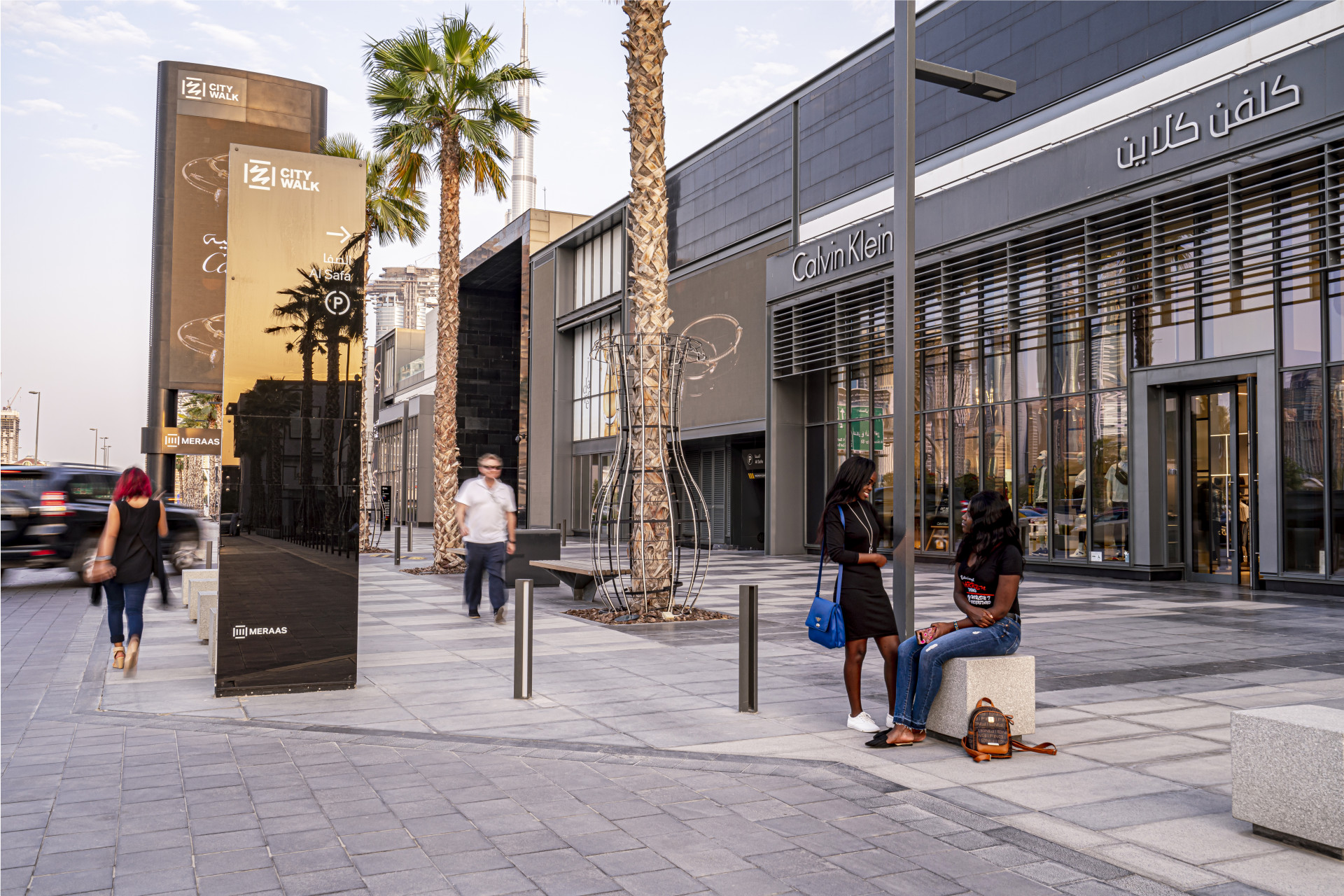Mixed use wayfinding strategy - shoppers sitting outside City Walk