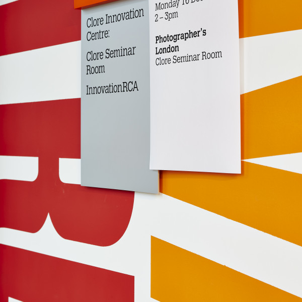 Royal College of Art orange wall mounted rail signs