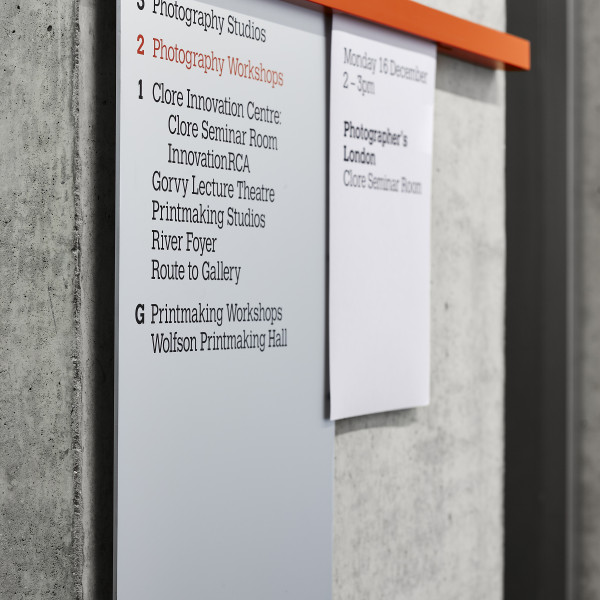Wayfinding signage by Endpoint - Royal College of Art orange wall mounted rail signs